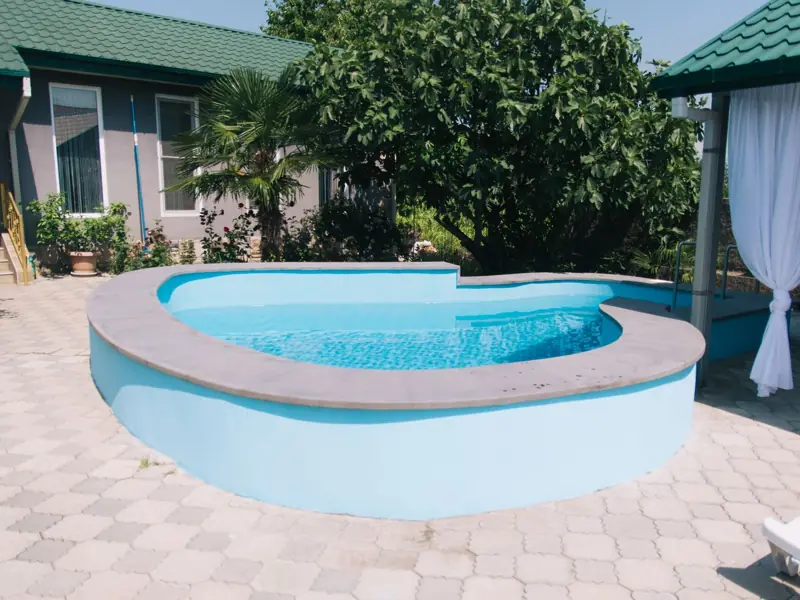 Stock photo of a backyard pool with a red arrow marking a fictional example finding